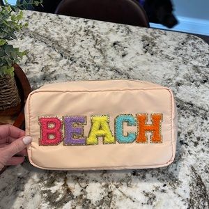 “beach” travel pouch. Super roomy and super cute!